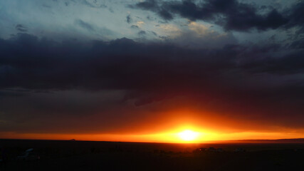 Fototapeta na wymiar sunset over the base camp of autotourists in Mongolia