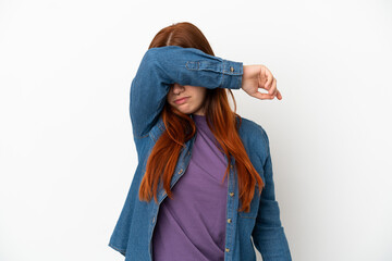 Young redhead woman isolated on white background covering eyes by hands