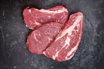 Raw Steaks. Sirloin Beef Steaks, Overhead View. Many Raw Striploin Steaks from Marbled Beef on...