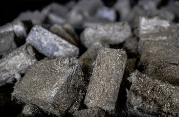 A lot of fuel briquettes from pressed sawdust. Briquettes for the oven close-up.