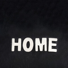 black fabric background with home word in white