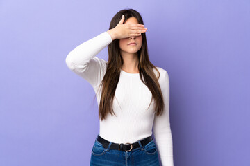 Teenager Brazilian girl over isolated purple background covering eyes by hands. Do not want to see something