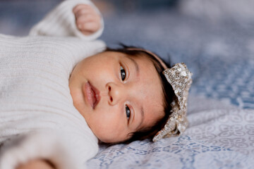 Newborn Hispanic baby lying in bed - newborn coming home