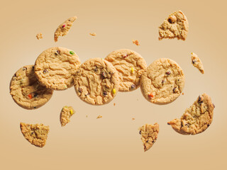 On a light beige background, beige cookies. Whole biscuits and pieces. Flight status. Levitation. Minimalism. There is an empty space for your insert. Pastel colors, bright lighting.