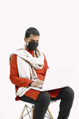 Man in protective mask work with laptop