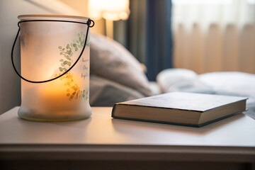 cozy bedroom detail focus on burning candle