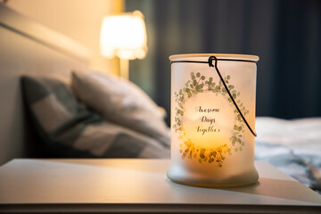 cozy bedroom detail focus on burning candle