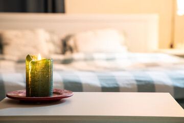 cozy bedroom detail focus on burning candle