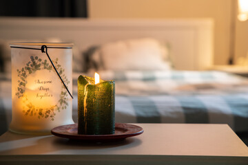 cozy bedroom detail focus on burning candle