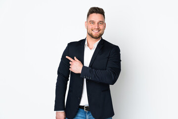 Young Russian business man isolated on white background pointing finger to the side