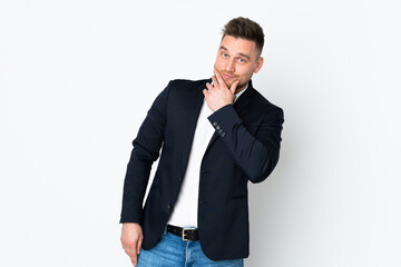 Young Russian business man isolated on white background thinking an idea