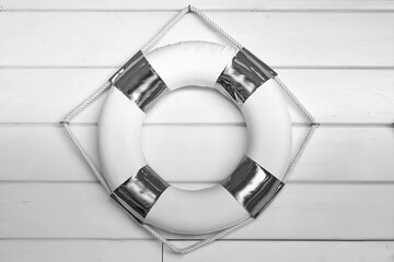 Lifebuoy Hanging On Vintage Wooden Background Texture. White Life Buoy With Color Ribbon Hang On...