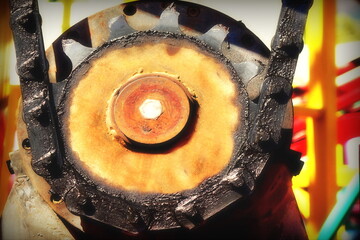 Old Gear Wheel Closeup View. Rusty Worn Chain Drive Close Up. Cogwheel And Chain With Graphite Or...