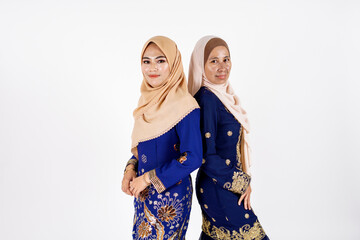 Studio portrait of mother and daughter dressed for an event. Fashion for dinner, event and feast day. Studio shot with white background.