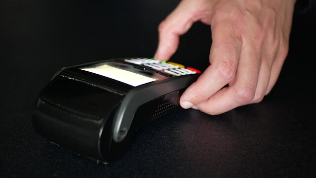 Point-of-sale terminal working. Customer pays for products, completes sale transaction and receives a receipt upon the finalization of their purchase