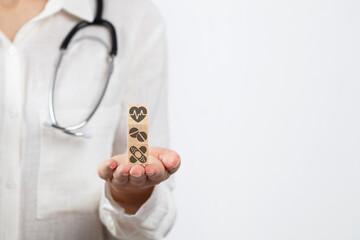 Wooden block with Medical and Health on wooden blocks concept.