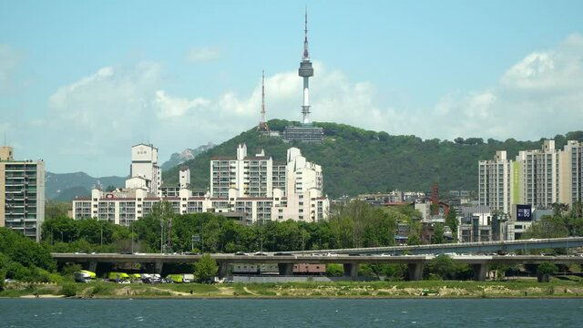 Patrol vessel on Hanriver, Namsan Seoul N tower and traffic on highway in Yongsan district, South Korea