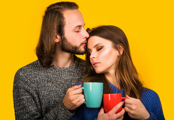 Family coziness concept. Couple in warm clothes with Cup of tea or coffee. Romantic moments.