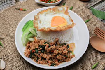 Thai Stir fried  basil with minced pork, chili and fried egg on topped rice. Thai local food style call 