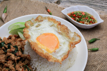 Thai Stir fried  basil with minced pork, chili and fried egg on topped rice. Thai local food style call 