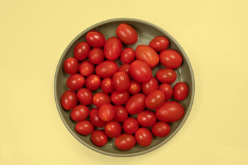 cherry tomatoes with water drops in ceramic bowl