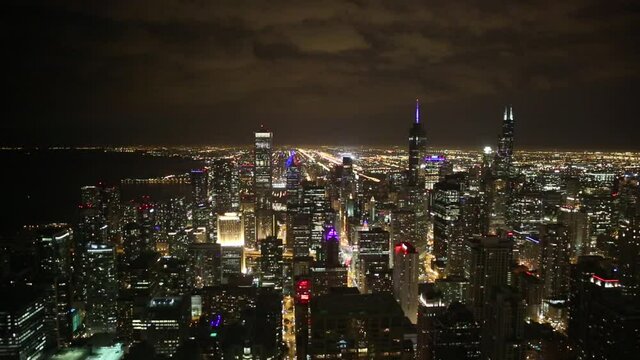 Aerial view of Chicago at night with lots of bright colorful lights, cityscape
