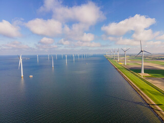 offshore windmill park with clouds and a blue sky, windmill park in the ocean aerial view with wind...