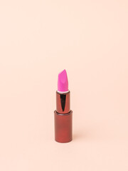 Pastel background with stylish women's lipstick.