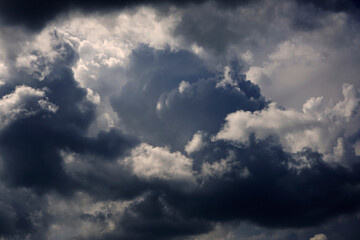 Stormy cumulus clouds view. Dramatic sky before a thunderstorm. Dark ominous low clouds. Cloudy gloomy sky background for design.