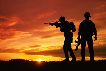 Fototapeta na wymiar Silhouette of a soldiers against the sunrise. Concept - protection, patriotism, honor.