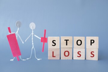 Human stick figure holding red candlestick pattern in dark blue background with word stop loss. Bearish market in stock market and crypto trading concept.