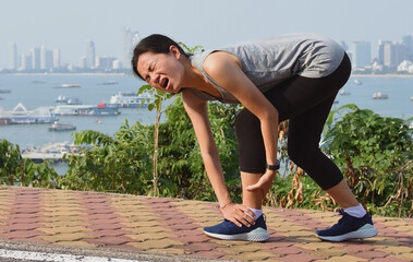 Running woman screaming in pain during running training.