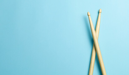 Drum sticks on a blue background. Template Copy space for text