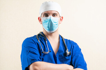 Doctor in blue uniform and medical mask.