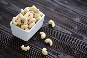 Full Raw Cashew Nuts in white ceramic bowl