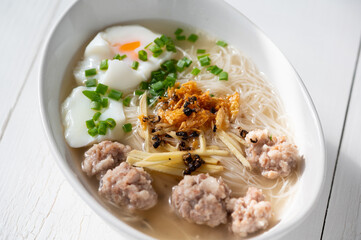 Thai style clear soup rice noodle in traditional bowl. Selective focus