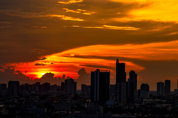Fototapeta premium The blurred abstract background of the morning sun exposure to the tiny dust particles that surround the tall buildings in the capital, the long-term health issue of pollution