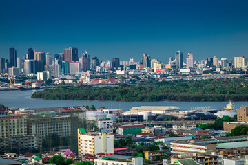 Fototapeta na wymiar Panorama background of city views, with colorful twilight sky, high-rise buildings (condominiums, offices, expressways) and blurred lights from roads and traffic.