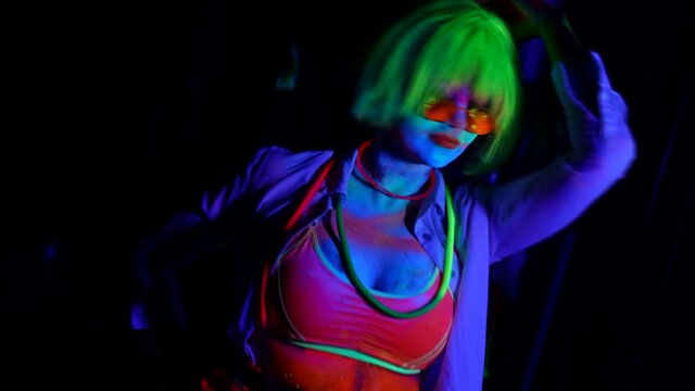 Art image of a woman in neon light bright fluorescent makeup, colored skin, body art design disco women
