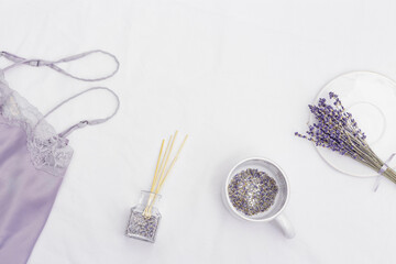 Healthy night sleep concept, pajamas, sleep mask, cup of lavender tea, aromas for better falling asleep, pillow