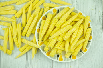 Heap of fresh young baby corn in dish