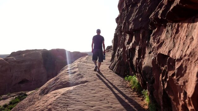 Man hiking in the canyons of Moab, Utah