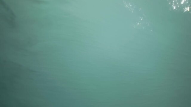 A big wave hitting the camera in slow motion on a sunny summer day.