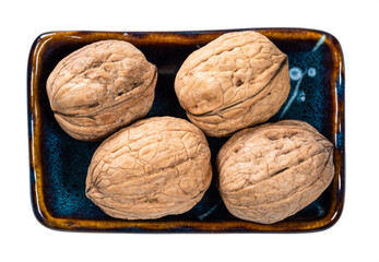 top view of several whole walnuts in bowl cutout