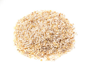 pile of crushed pot barley groats closeup on white