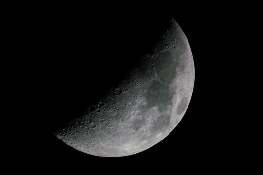 View of a waxing gibbous moon just short of a half moon.