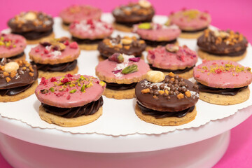 Sandwich cookies with chocolate cream and fruit on white plate