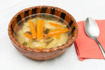 Plate of vegetable soup served in a clay pot. Healthy food.