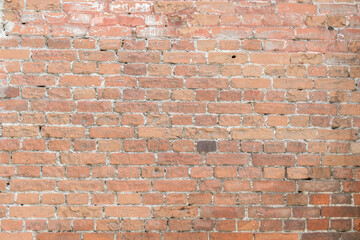 Old brick wall for a backdrop. White cement joints. The color of the bricks is pink, brown.
