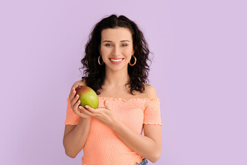 Beautiful woman with fresh mango on color background